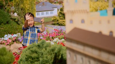 A child playing amongst the miniature sculptures and displays at Cockington Green.